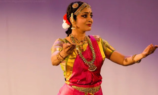 Jyothsna demonstrates Bharatanatyam in a colorful outfit.