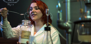 An actress pretends to work in a lab.