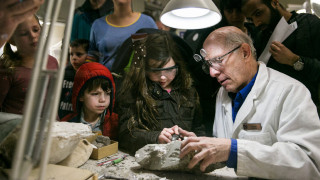 NHMU Volunteer Hook Ershler Works demonstrates fossil prep with DinoFest guests. 