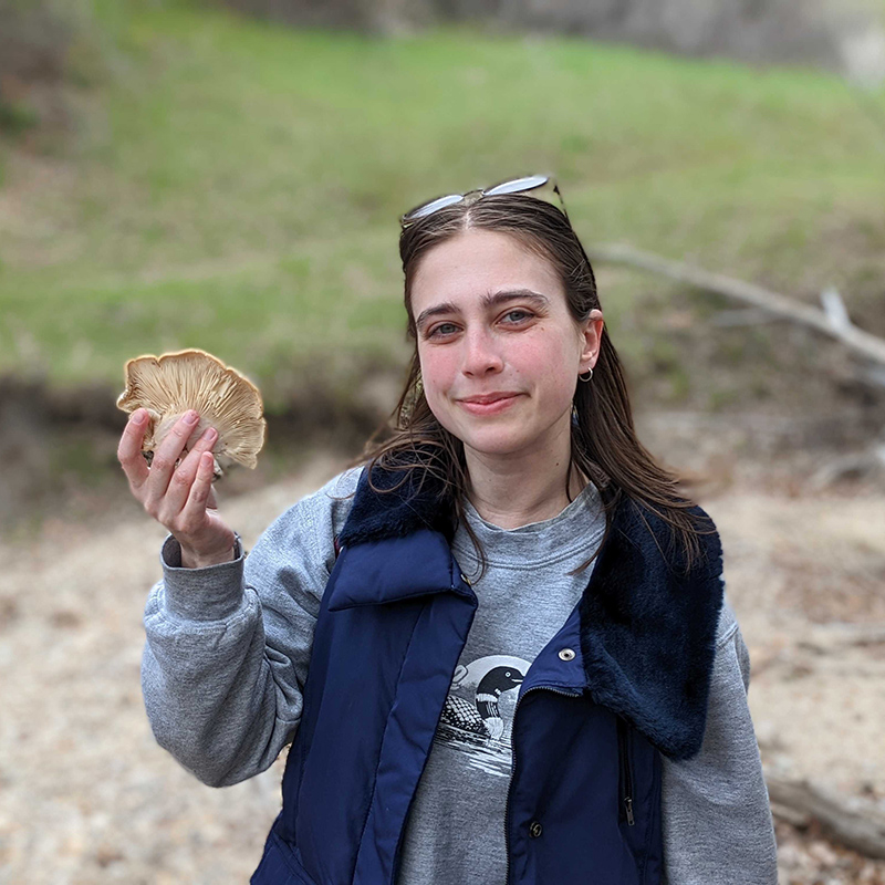 Kendra Autumn holding a mushroom.