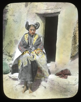 A lantern slide of a Hopi girl in traditional dress. 