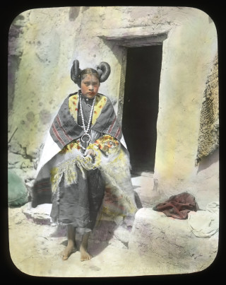 A lantern slide of a Hopi girl in traditional dress.