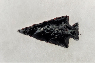 A black obsidian projectile point