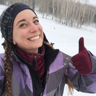 A woman gives a thumbs up