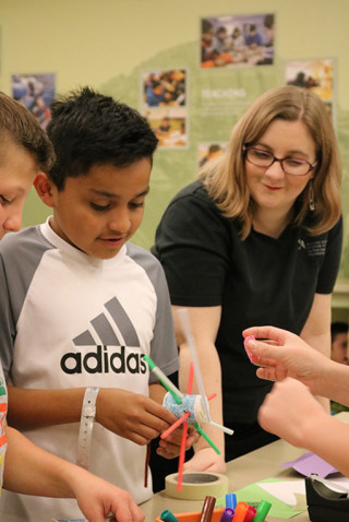 Katie works with students in a classroom.