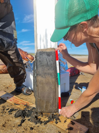 A scientist inspects a core sample taken from the lake.