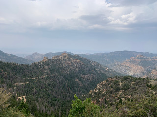 an outdoor mountain scene of tree covered mountains