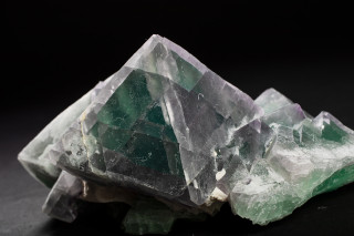 Cleavage lines in a cluster of large multicolor octahedrons of fluorite.