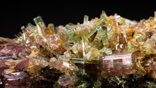 A cluster of elbaite crystals where smaller crystals grew out of the side of a group of larger crystals.