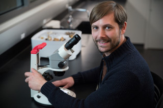 Dentiger smiling with microscope