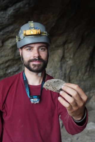 Kaedan O’Brien holds up a mummified wood rat at an undisclosed cave in the House Range of western Utah.