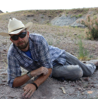 Dr. Joseph Petersen lounges on the side of the mountain