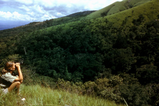 Jane Goodall in the field with binoculars