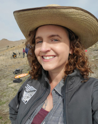 Elizabeth Hora smiles while standing outside.