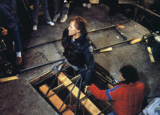 Fernando Favila works on the model of a human figure on the set of Robocop.