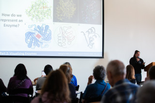 A woman giving a talk at a science cafe