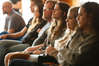 Guests watching a Scientist give a presentation