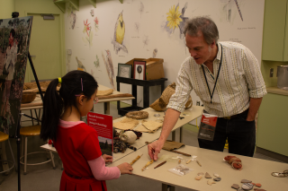 A scientist talks to a young girl about science