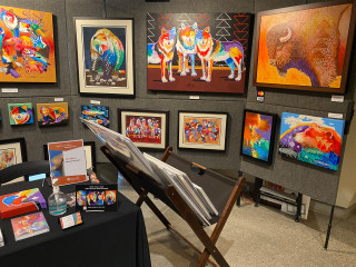 A booth full of paintings. 