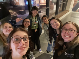 A group of young women take a selfie. 