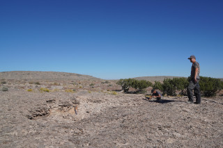 Scientists examine bedrock.