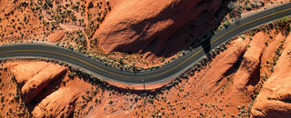 A road winds through the desert. 