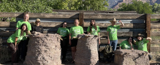 Students stand next to their experimental granaries. 
