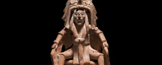 A figurine part of a Mayan blood letting bowl