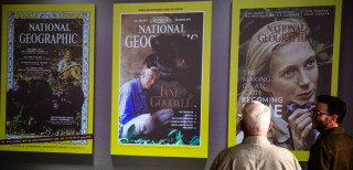 Guest stand before a projection that shows the National Geographic covers featuring Jane Goodall.