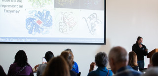 A woman giving a talk at a science cafe