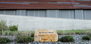 A rock inscribed with poetry outside a museum. 