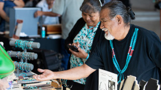 A vendor selling Native American art and jewelry.