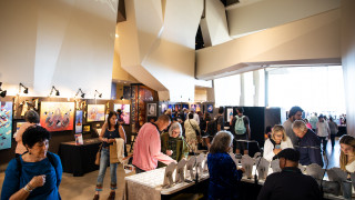 Guests browse booths at the Indigenous Art Market inside the Museum.