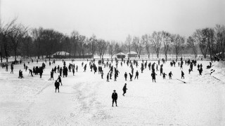 A historic photo of people ice skating on a frozen pond. 