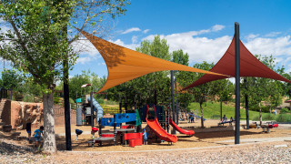A neighborhood park with shade structures. 
