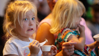 A kid reacts to eating an insect at BUGfest