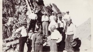 A historic black and white photo of a group of men at a quarry.