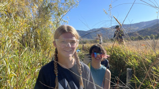 Two Critical Action Lab fellows helping restore a stream!