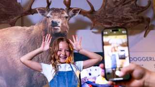 girl mimics antlers