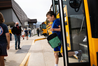 Student gets off of school bus