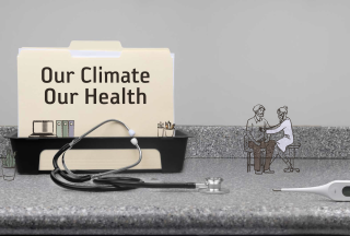 A stethoscope and file with text &quot;Our Climate Our Health&quot; on a countertop