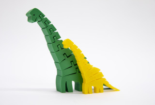 Two Sauropod plastic toys are displayed side by side on a white background.