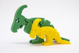 Two Parasaurolophus plastic toys are displayed side by side on a white background.
