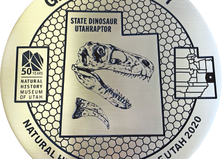 Grand County Explorer Corps marker featuring a dinosaur fossil