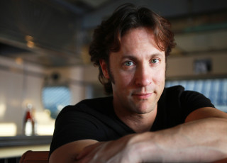 David Eagleman looks at the camera with a soft smile.