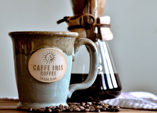 A cup of coffee with the Cafe Ibis logo.