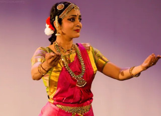Jyothsna demonstrates Bharatanatyam in a colorful outfit.