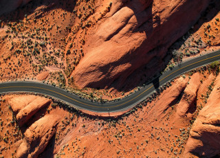 A road winds through the desert. 