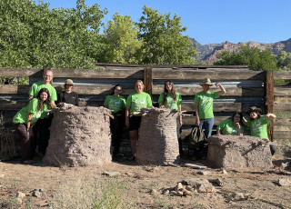 Students stand next to their experimental granaries. 