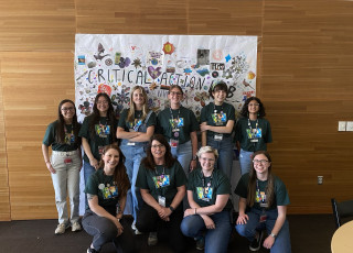 A group of young people pose in a group photo together